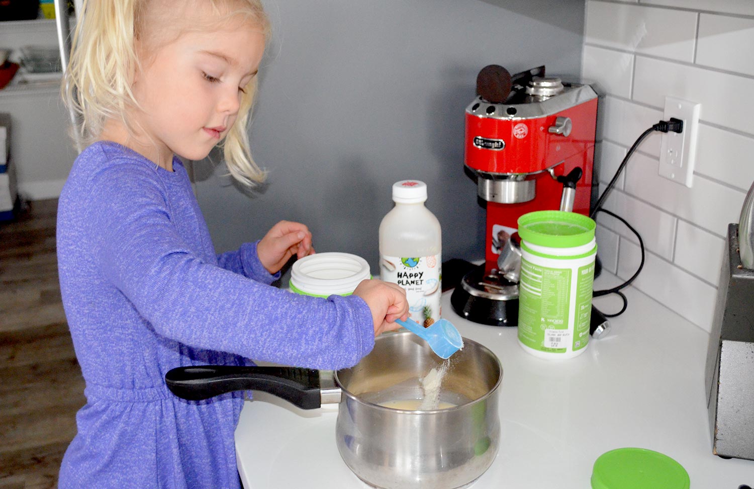 Halloween Gummies Little girl putting gelatin into a pot