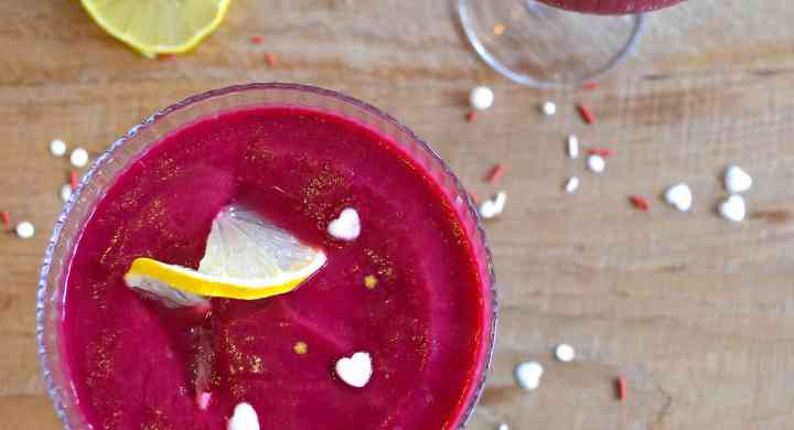 Strawberry Lemonade Detox Smoothie Two bright pink smoothies in cocktail glasses, with lemon twists and heart and star sprinkles.