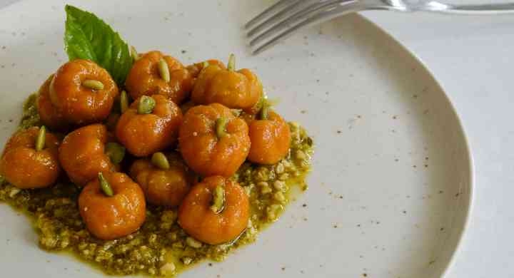 Pumpkin Pasta Plate of pumpkin-shaped orage pasta on a bed of pesto.